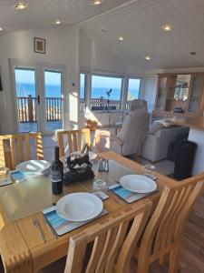 a dining room with a table with plates on it at Bayview Luxury Lodge in Cockburnspath