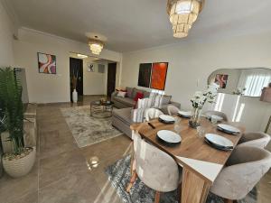 a living room with a table and a couch at Elite 3 BR Apartment in Zayed in Sheikh Zayed