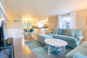 a living room with a couch and a table at Less than 5 Miles to Rock Harbor in Orleans