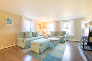 a living room with two couches and a tv at Less than 5 Miles to Rock Harbor in Orleans