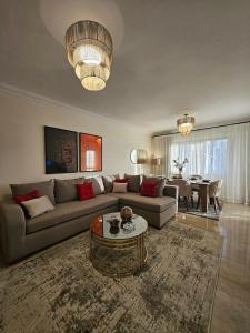 a living room with a couch and a table at Elite 3 BR Apartment in Zayed in Sheikh Zayed