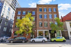 three cars parked in front of a brick building at The Mercer Boutique Hotel in Montreal