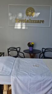 a bedroom with a bed and a table with chairs at Pousada Encantos do Estaleiro in Balneário Camboriú +50 photos
