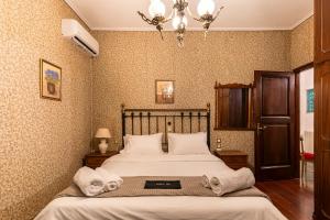 a bedroom with a bed with towels on it at Gkr Luxury Villa in Aghia Marina +114 photos