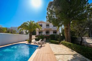 a swimming pool in front of a house at Gkr Luxury Villa in Aghia Marina
