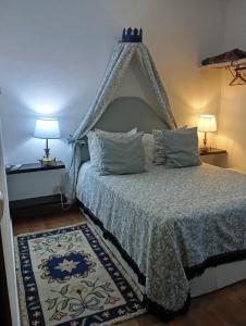 a bedroom with a bed with a canopy at Quinta do Freixo in Reguengos de Monsaraz