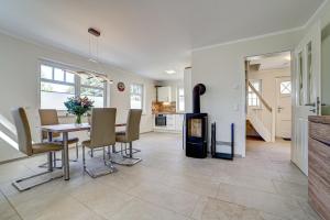 a kitchen and dining room with a table and chairs at Strandvej in Prerow