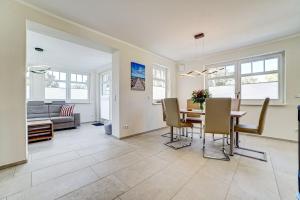 a dining room and living room with a table and chairs at Strandvej in Prerow
