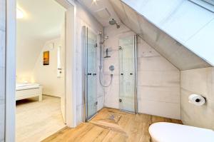 a bathroom with a shower and a toilet in a room at Strandvej in Prerow +18 photos