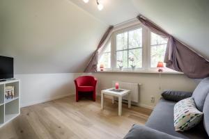 a living room with a couch and a window at Deichblick in Prerow