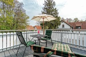 a patio with a table and chairs and an umbrella at Deichblick in Prerow