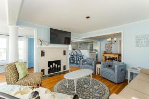 a living room with a couch and a fireplace at Oceanfront Cottage - Steps from Short Sands Beach! in York