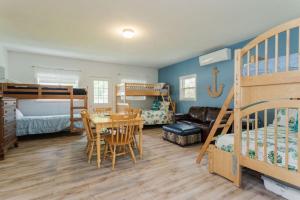 a bedroom with bunk beds and a dining room with a table at Oceanfront Cottage - Steps from Short Sands Beach! in York