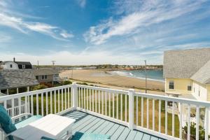 a balcony with a view of a beach at Oceanfront Cottage - Steps from Short Sands Beach! in York