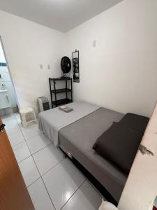 a bedroom with a large bed in a white room at Conteiner House in Pipa +15 photos