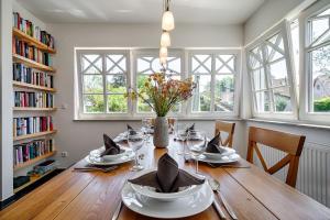 a dining room table with a vase of flowers on it at Min Leefste in Prerow