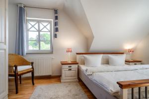 a bedroom with a bed and a chair and a window at Min Leefste in Prerow