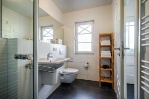 a bathroom with a toilet and a sink at Min Leefste in Prerow +10 photos