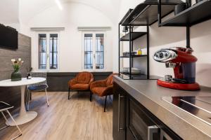 a kitchen with a red appliance on a counter at Ca' Lumaga -Charming Holiday Studio in Chiavenna