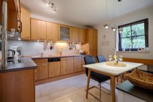 a kitchen with wooden cabinets and a table with chairs at Emma in Prerow