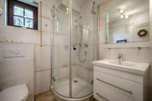 a bathroom with a shower and a toilet and a sink at Emma in Prerow +7 photos