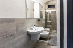 a bathroom with a sink and a toilet at Ca' Lumaga -Charming Holiday Studio in Chiavenna +21 photos