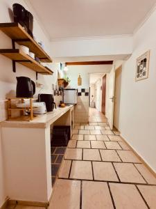 a kitchen with a counter and a tile floor at Departamento céntrico in Esquel +2 photos