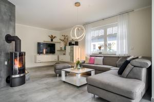 a living room with a couch and a fireplace at Strandzeit in Prerow