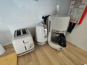 two coffee machines sitting on top of a counter at Douro Garden in Resende