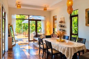 a dining room with a table and chairs at SAMUI BOHO Family Villa 4BR with Pool Renovated 2026 in Nathon Bay