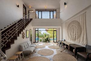 a living room with a staircase and a living room with a couch at SAMUI BOHO Family Villa 4BR with Pool Renovated 2026 in Nathon Bay +17 photos