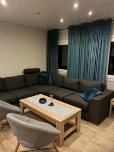 a living room with a couch and a coffee table at Sætervika Floating home in Hosen