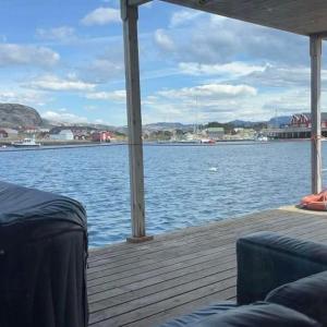 a dock with a view of a body of water at Sætervika Floating home in Hosen