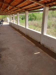an empty parking lot with a motorcycle in the distance at Sitio de Antonio à 18km do parque do povo in Campina Grande