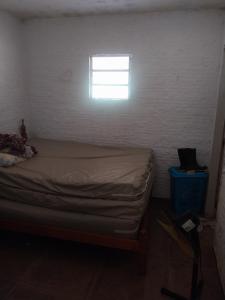 a small bedroom with a bed and a window at Sitio de Antonio à 18km do parque do povo in Campina Grande
