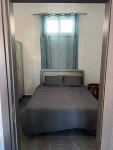 a bed in a small room with a window at Central Stone Living in Peyia