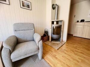 a living room with a chair and a television at Ferienwohnung Westi in Thiessow