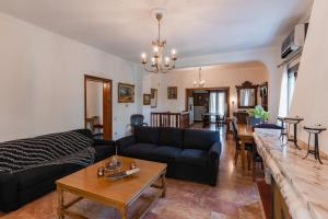 a living room with a couch and a table at Gkr Luxury Villa in Aghia Marina