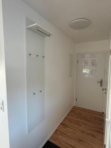 a room with white walls and a glass door at Wohnung in Kirchheim in Kirchheim unter Teck