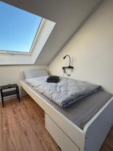 a bed in a room with a large window at Wohnung in Kirchheim in Kirchheim unter Teck