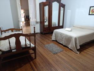 a bedroom with two beds and a mirror at Renata in Carmelo