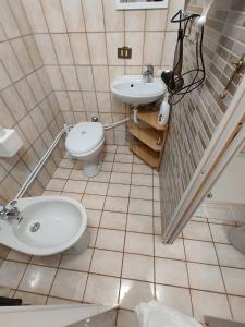 a bathroom with a sink and a toilet at Marilleva 1400 - Alpine Apartment in Marilleva +5 photos