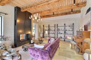 a living room with purple furniture and a fireplace at LA BASTIDE DES CULS-ROUSSET in Marseille