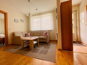 a living room with a couch and a table at Ferienwohnung Boston Terrier in Thiessow