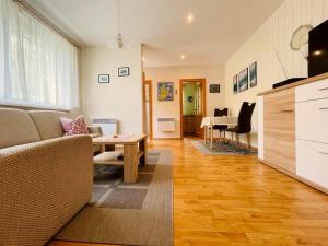 a living room with a couch and a table at Ferienwohnung Boston Terrier in Thiessow