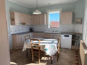 a kitchen with a table and chairs in it at La Parenthèse in Sagy