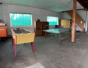 a room with a ping pong table in a room at La Parenthèse in Sagy +2 photos