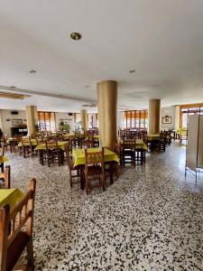 a restaurant with tables and chairs in a room at Hotel Acebo & Natura in Castiello de Jaca +72 photos