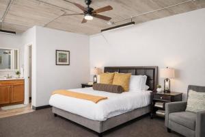 a bedroom with a bed and a ceiling fan at Charming Appleton Condo Downtown Modern Loft in Appleton