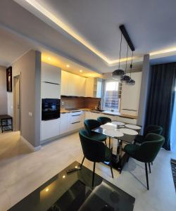 a kitchen and dining room with a table and chairs at Davids place 2 in Floreşti